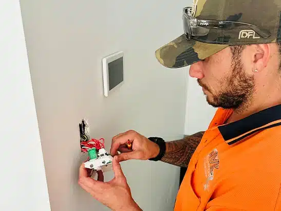 JVK licensed electrician working on switchboard in Gold Coast home
